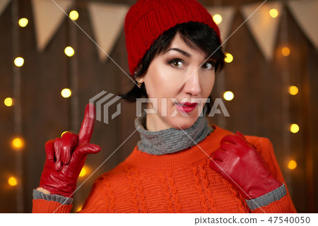 Beautiful woman posing on dark wooden background Beautiful woman posing on dark wooden background 47540050
