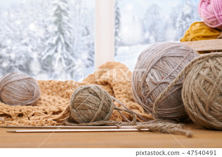 Woolen yarn and fabric on the window sill 47540491