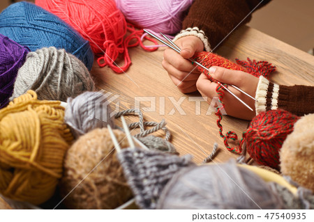 Child is learning to knit. Colorful wool yarns 47540935