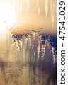 Sunset the sun shines through the frozen window 47541029