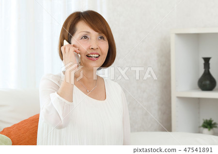 A woman wearing a smartphone A woman wearing a smartphone 47541891