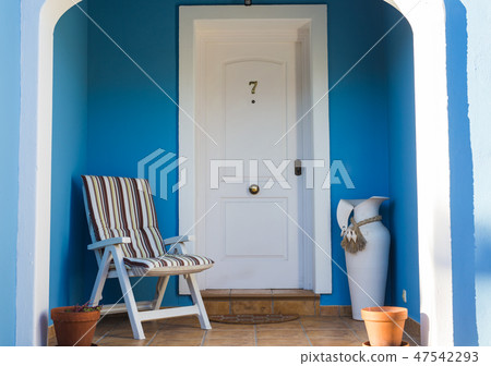 Decor, design and building concept - A nice entrance of the house with chair and vase Decor, design and building concept - A nice entrance of the house with chair and vase 47542293