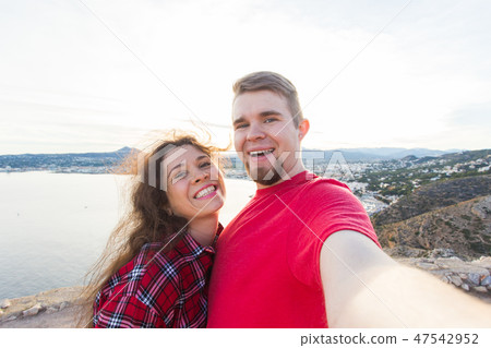 Travel, vacation and holiday concept - Happy couple taking selfie over beautiful landscape Travel, vacation and holiday concept - Happy couple taking selfie over beautiful landscape 47542952