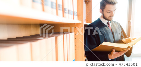 Lawyer with robe ready for court reading after the law one last time 47543501