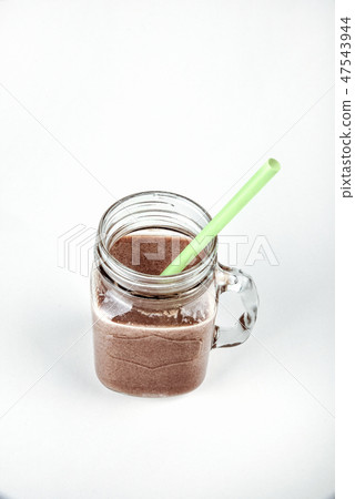 Fresh protein shake, milk with cocoa in a glass jar on a white background Fresh protein shake, milk with cocoa in a glass jar on a white background 47543944