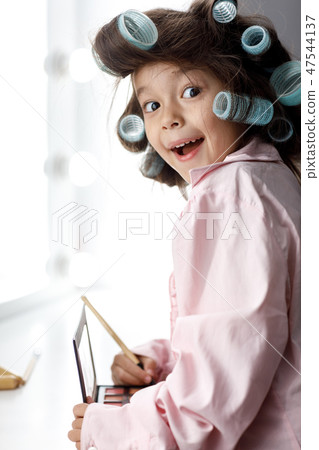 Cute little girl playing with her mother's cosmetic Cute little girl playing with her mother's cosmetic 47544137