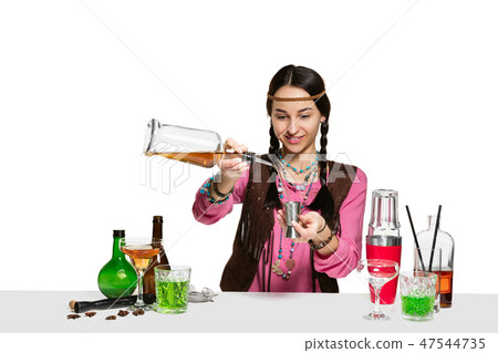 Expert female barman is making cocktail at studio 47544735