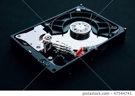 Hard drive assembly uncovered, arm and platters Hard drive assembly uncovered, arm and platters 47544741