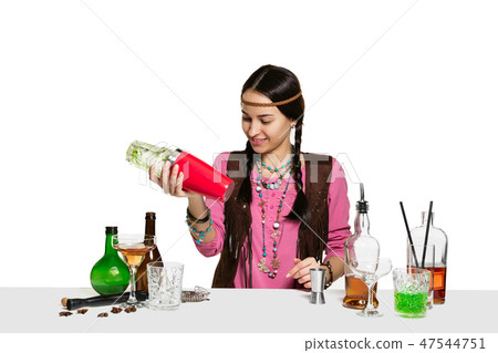 Expert female barman is making cocktail at studio 47544751