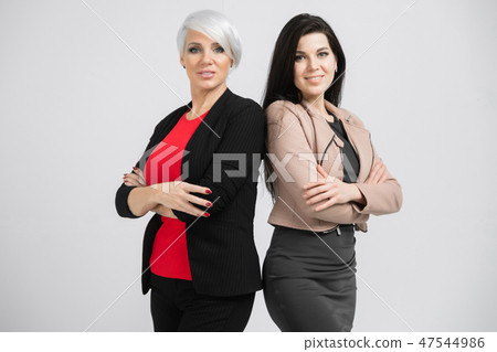 Portrait of waist-deep Two young girls standing back-to-back isolated on white background 47544986