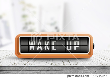 Wake up alarm clock on a table in a bright room 47545043