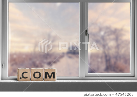 Com sign in a bright window with a view 47545203
