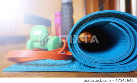 Close up of yoga, fitness floor mat at home in a roll. Healthy concept 47545646