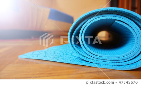 Close up of yoga, fitness floor mat at home in a roll. Healthy concept Close up of yoga, fitness floor mat at home in a roll. Healthy concept 47545670