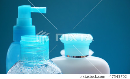 Blue cosmetic tube on blue background. Blank plastic container, packaging design 47545702