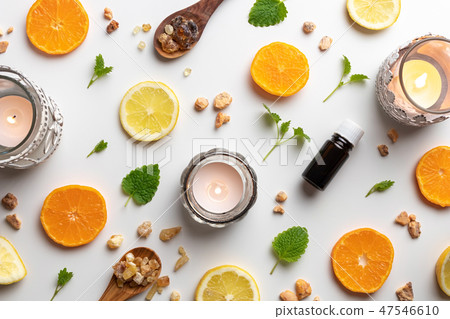 Bottles of essential oil with tangerines and lemon Bottles of essential oil with tangerines and lemon 47546610