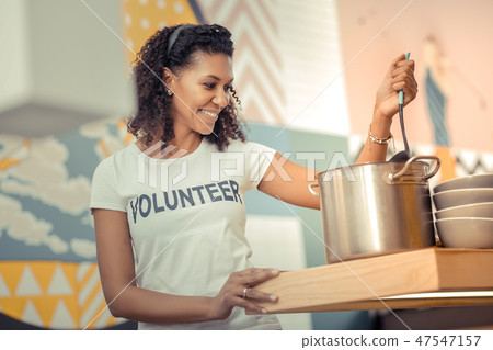 Delighted happy woman cooking in the kitchen Delighted happy woman cooking in the kitchen 47547157