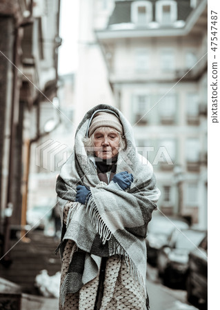 Sad serious aged woman closing her eyes 47547487