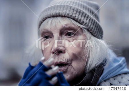 Portrait of a gloomy poor elderly woman 47547618
