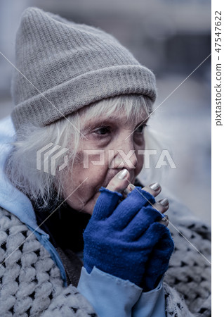 Sad poor woman being outside in winter 47547622
