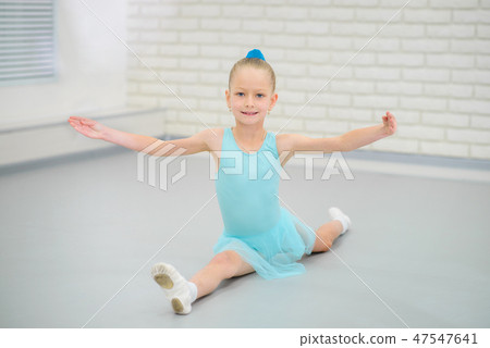 Little ballerina in blue dress and pointe shoes is dancing in ballet school. Cute girl in dance Little ballerina in blue dress and pointe shoes is dancing in ballet school. Cute girl in dance 47547641