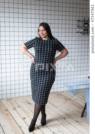 Happy beautiful and confident plus size girl posing in studio Happy beautiful and confident plus size girl posing in studio 47547981
