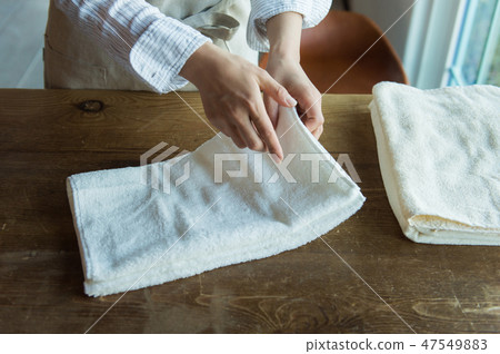 Hand of a woman who clashes a towel Hand of a woman who clashes a towel 47549883