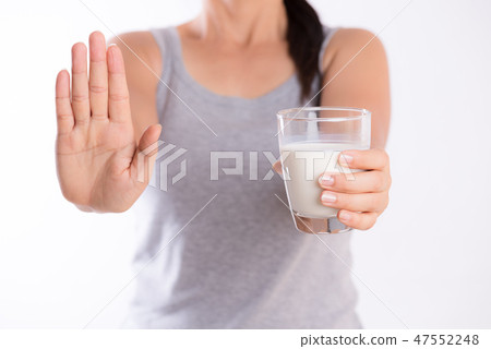 Woman hand holding glass of milk  47552248