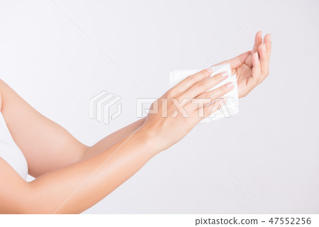 Woman cleaning her hands with a tissue. Woman cleaning her hands with a tissue. 47552256