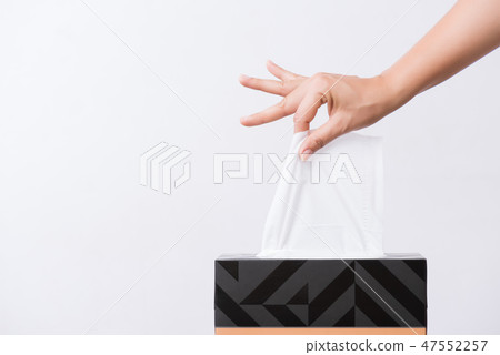 Woman hand picking white tissue paper from box Woman hand picking white tissue paper from box 47552257