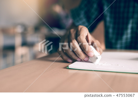 Close up student using eraser for edit mistake. Close up student using eraser for edit mistake. 47553067