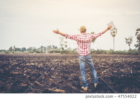 smart farmer using technology in agriculture field 47554022