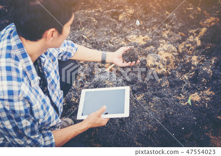 smart farmer using technology in agriculture field 47554023