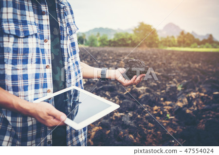 smart farmer using technology in agriculture field 47554024