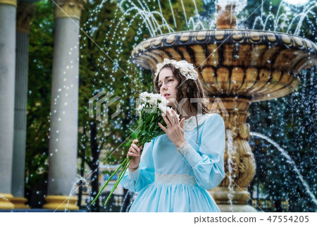 Portrait girl with a bouquet in vintage dress 47554205