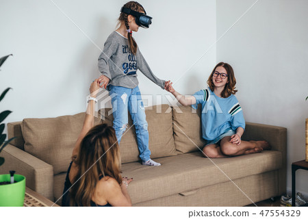 Little child girl playing game in virtual reality glasses Little child girl playing game in virtual reality glasses 47554329