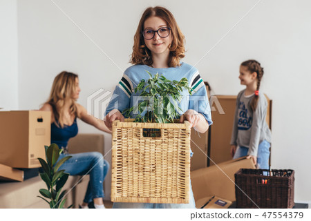 Family with cardboard boxes. Moving into new home Family with cardboard boxes. Moving into new home 47554379