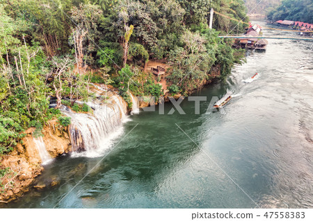 Wooden boat sailing river kwai with waterfall Wooden boat sailing river kwai with waterfall 47558383