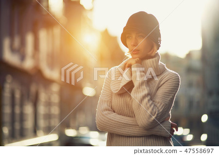 Fashion woman portrait of young girl in a knitted sweater outdoors 47558697