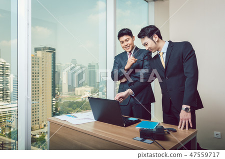 Businessman showing on laptop to his colleague Businessman showing on laptop to his colleague 47559717