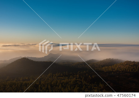Ultra long exposure of mountains, clouds and blue sky at dusk 47560174