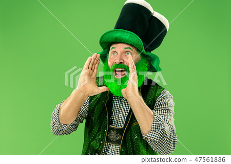 A man in a leprechaun hat at studio. He celebrates St. Patrick's Day. 47561886