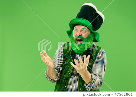 A man in a leprechaun hat at studio. He celebrates St. Patrick's Day. 47561901