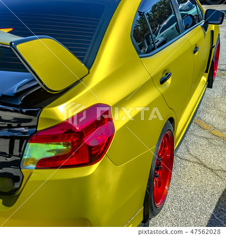 Metallic yellow car with bright red wheel rim 47562028