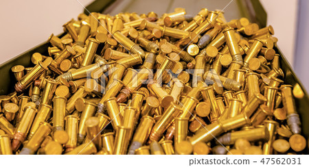 Metal box filled with cylindrical golden bullets 47562031