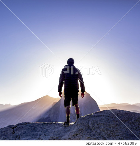 Man looking at spectacular mountains in Yosemite Man looking at spectacular mountains in Yosemite 47562099