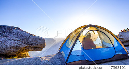 Man inside a tent in Yosemite with Half Dome view Man inside a tent in Yosemite with Half Dome view 47562101