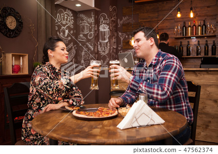 Lovely couple in new pub enjoying their beer. Lovely couple in new pub enjoying their beer. 47562374