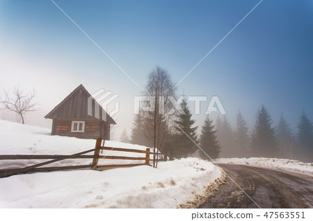 Lone house in mountain village. Foggy weather Lone house in mountain village. Foggy weather 47563551