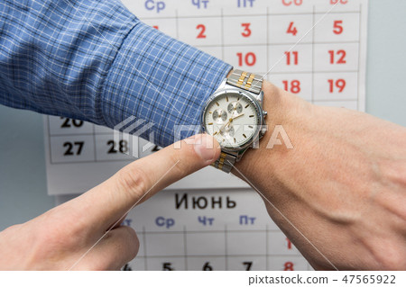Office specialist's hand points to a wristwatch, Office specialist's hand points to a wristwatch, 47565922